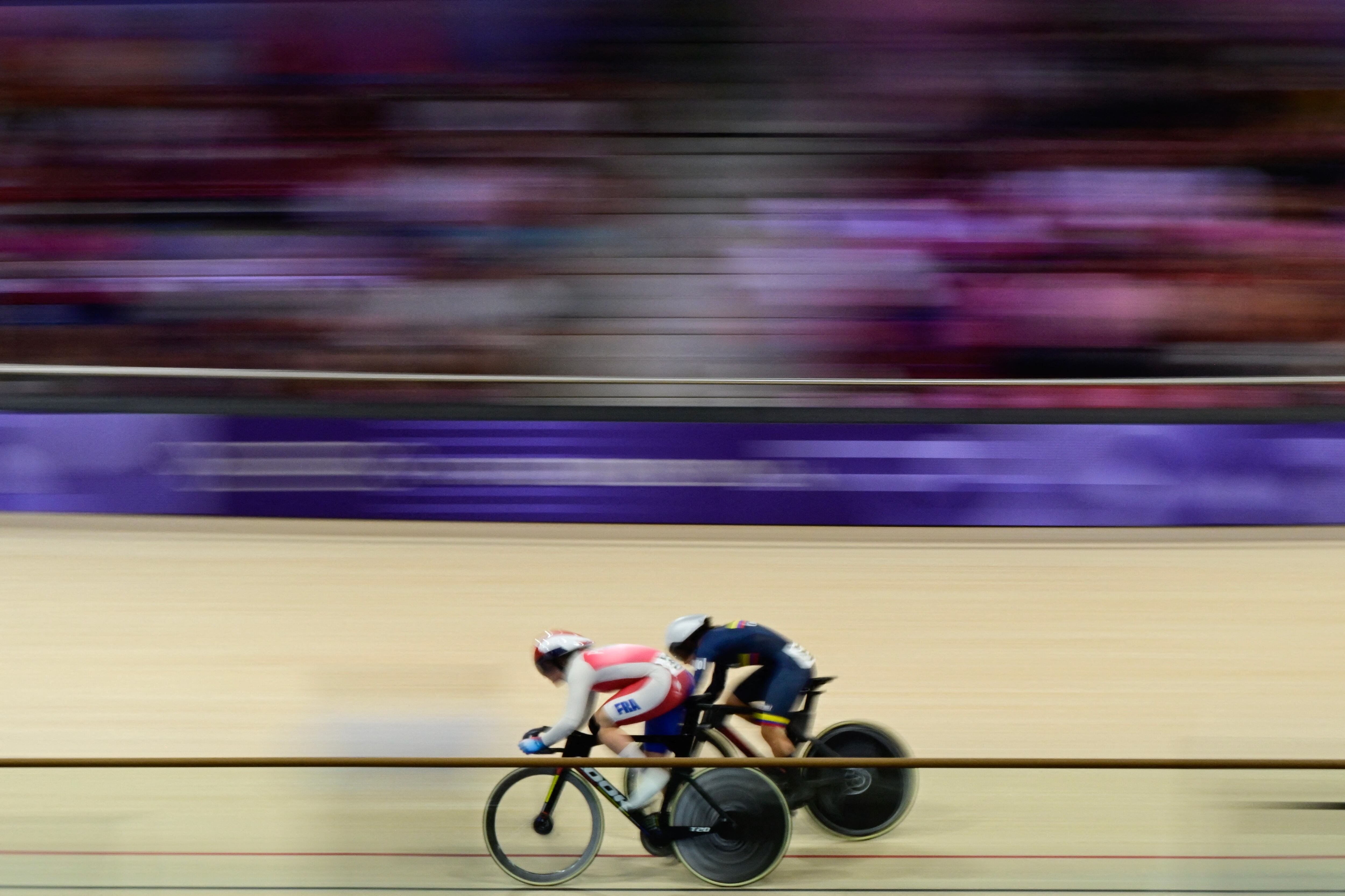 France's Mathilde Gros and Colombia's Martha Bayona Pineda compete in the women's track cycling sprint 1/16 final of the Paris 2024 Olympic Games at the Saint-Quentin-en-Yvelines National Velodrome in Montigny-le-Bretonneux, south-west of Paris, on August 9, 2024. (Photo by John MACDOUGALL / AFP)