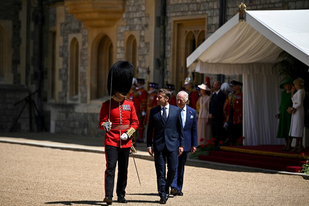 El rey Carlos III de Gran Bretaña y el presidente francés, Emmanuel Macron (centro), asisten a una ceremonia de bienvenida en el Castillo de Windsor, Inglaterra, el martes 8 de julio de 2025, en el primer día de una visita de Estado de tres días al Reino Unido. (Dylan Martinez/Pool vía AP)