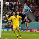 Uruguay's Matias Vina jumps for a ball in an attempt to score against South Korea's goalkeeper Kim Seung-gyu during the World Cup group H soccer match between Uruguay and South Korea, at the Education City Stadium in Al Rayyan , Qatar, Thursday, Nov. 24, 2022.