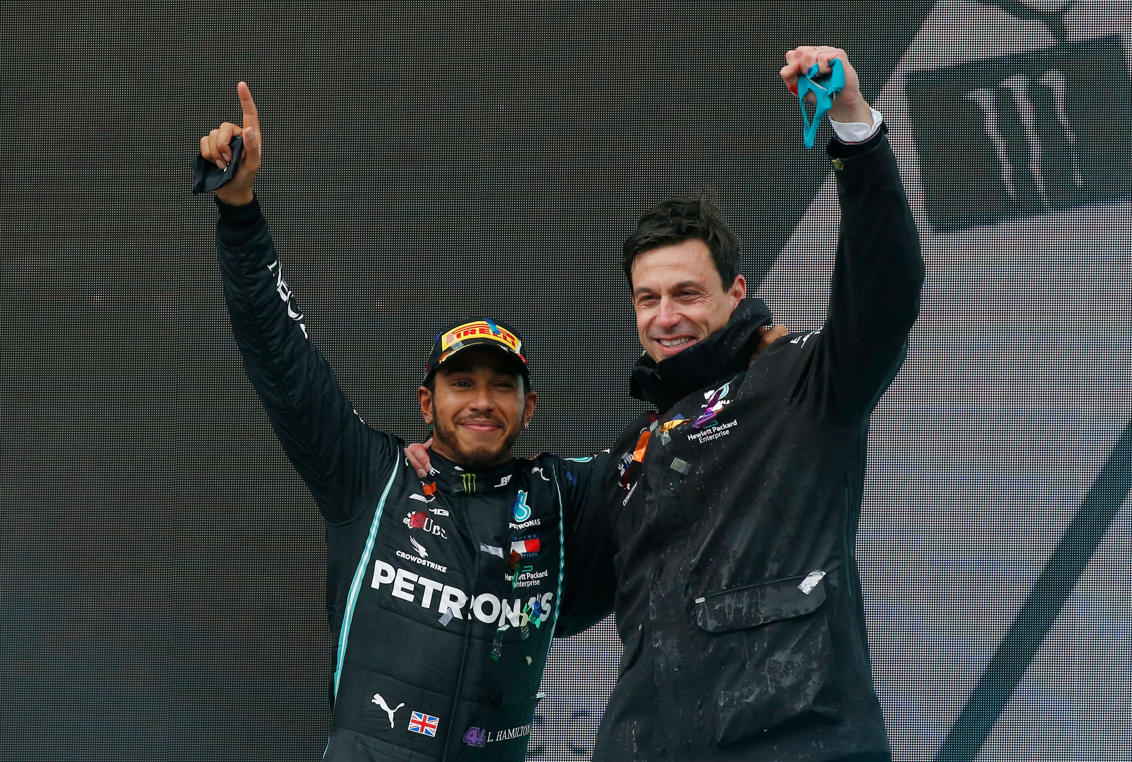 FILE  - Mercedes driver Lewis Hamilton of Britain and Mercedes team principal Toto Wolff, right, celebrate after Hamilton won the race and his seventh world championship at the Formula One Turkish Grand Prix at the Istanbul Park circuit racetrack in Istanbul, Sunday, Nov. 15, 2020.  Lewis Hamilton’s decision to leave Mercedes for Ferrari shocked the Formula One world with even Mercedes team principal Toto Wolff calling it a