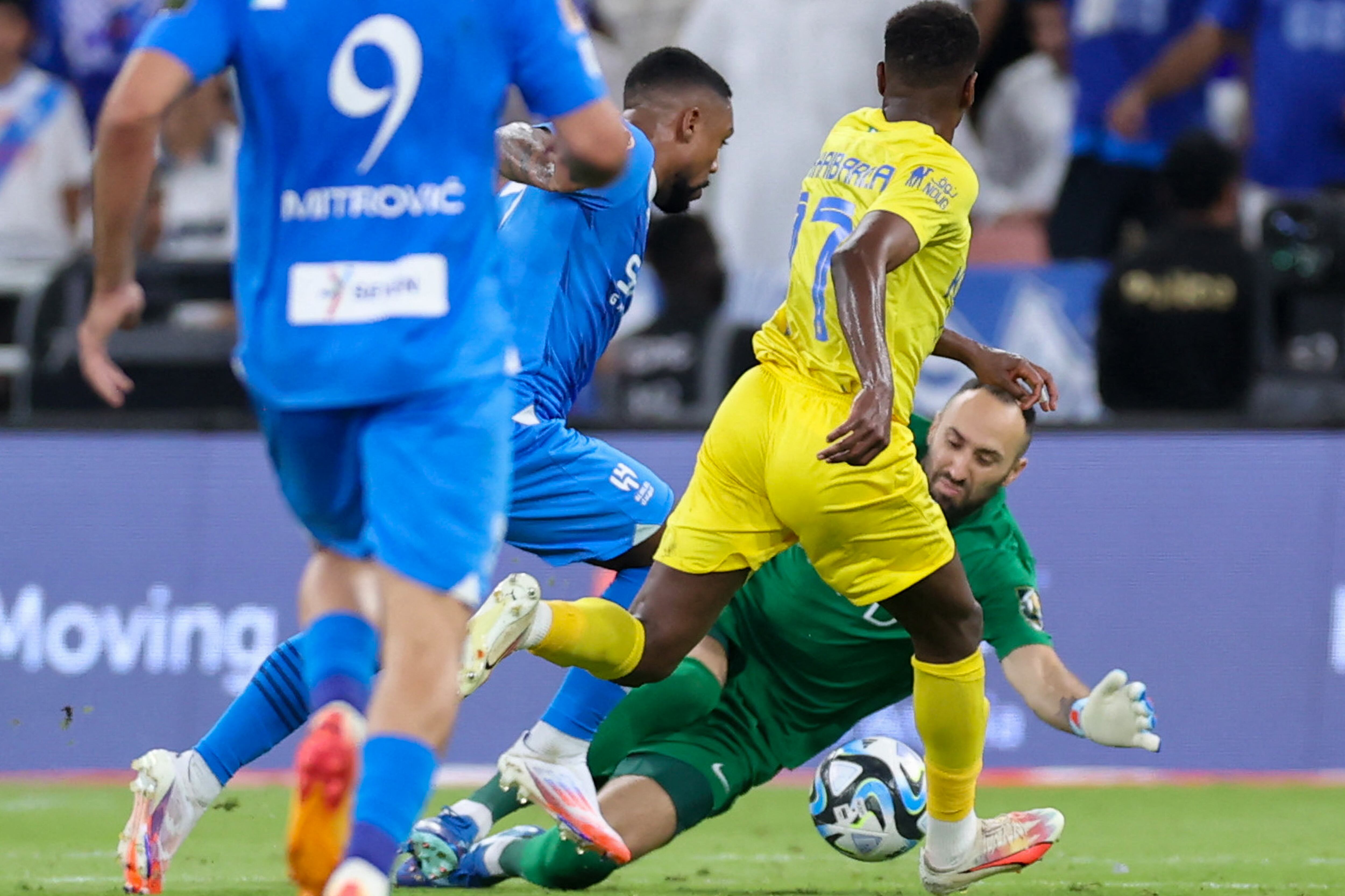 Nassr's Colombian goalkeeper #26 David Ospina dives for the ball in front of Hilal's Brazilian forward #77 Malcom during the King's Cup final match between Al-Nassr and Al-Hilal at the King Abdullah Sport City Stadium in Jeddah on May 31, 2024. (Photo by AFP)