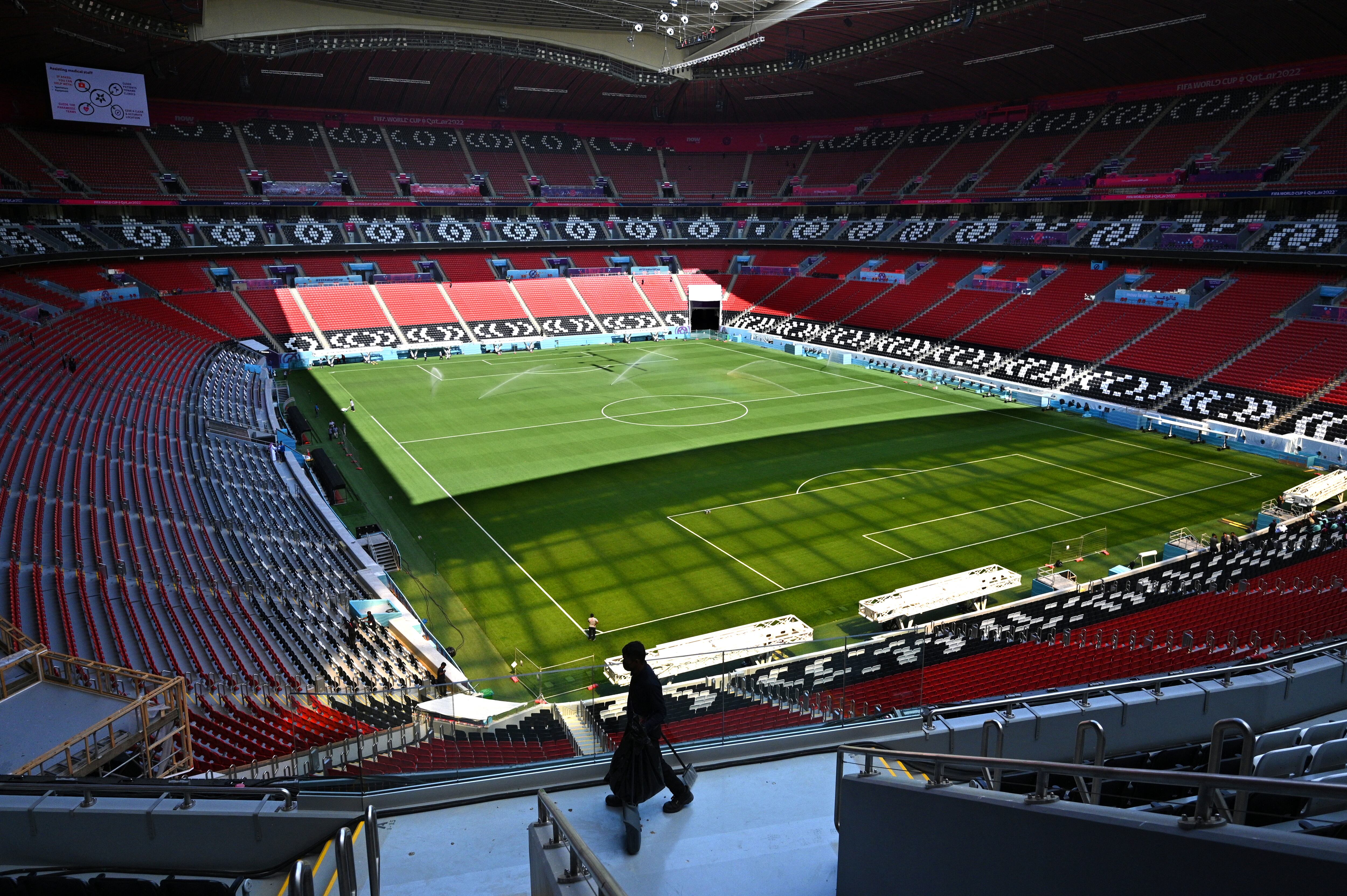 A worker walks inside the Al-Bayt Stadium in al-Khor on November 12, 2022, ahead of the Qatar 2022 FIFA World Cup football tournament. (Photo by Gabriel BOUYS / AFP)