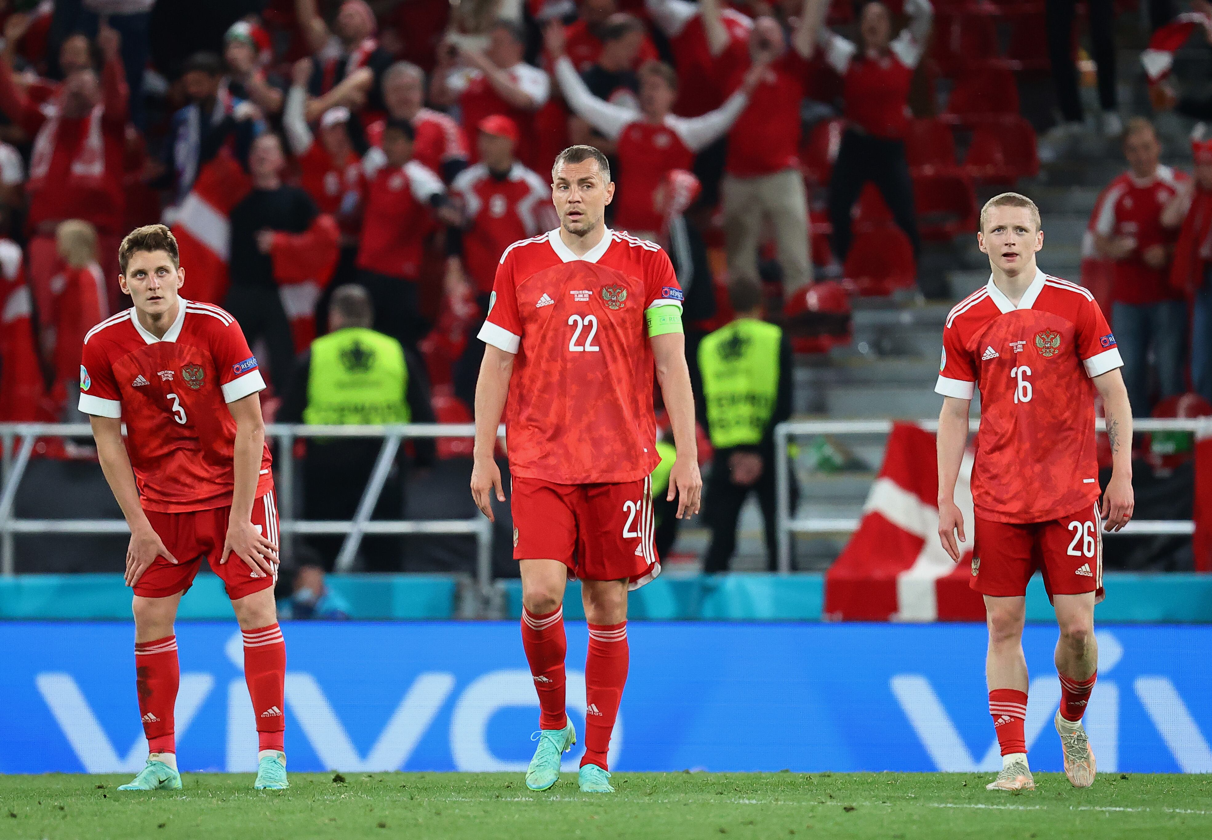 COPENHAGEN, DENMARK - JUNE 21: (L - R) Igor Diveev, Artem Dzyuba and Maksim Mukhin of Russia look dejected after the Denmark fourth goal scored by Joakim Maehle during the UEFA Euro 2020 Championship Group B match between Russia and Denmark at Parken Stadium on June 21, 2021 in Copenhagen, Denmark. (Photo by Wolfgang Rattay - Pool/Getty Images)