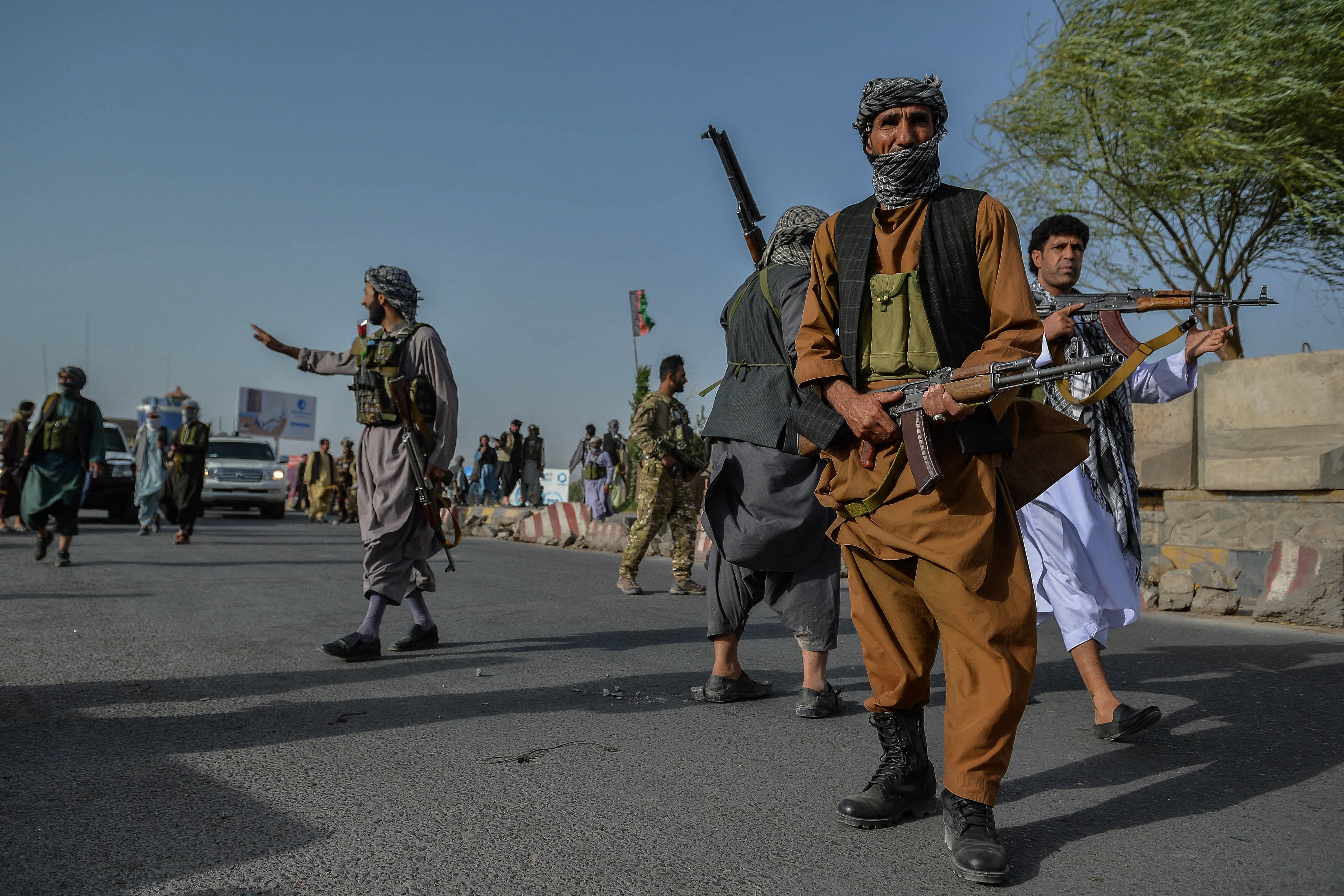 Afghan security personnel and Afghan militia fighting against Taliban, stand guard in Enjil district of Herat province on July 30, 2021. (Photo by Hoshang Hashimi / AFP)