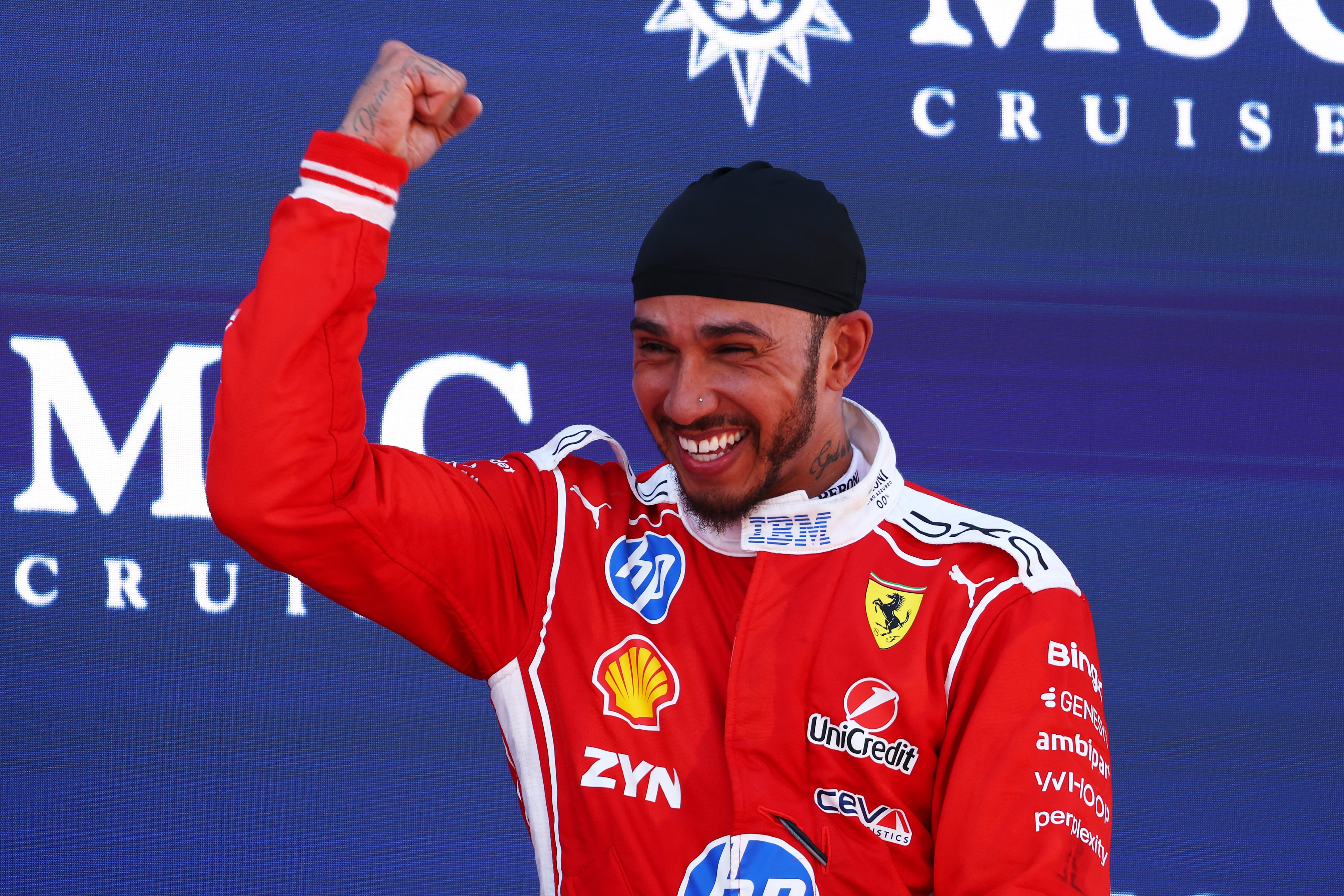BARCELONA, SPAIN - JUNE 14: Race winner Lewis Hamilton of Great Britain and Scuderia Ferrari and Carlo Santi, Race Engineer at Ferrari on the podium during the F1 Grand Prix of Barcelona-Catalunya at Circuit de Barcelona-Catalunya on June 14, 2026 in Barcelona, Spain. (Photo by Clive Rose/Getty Images)