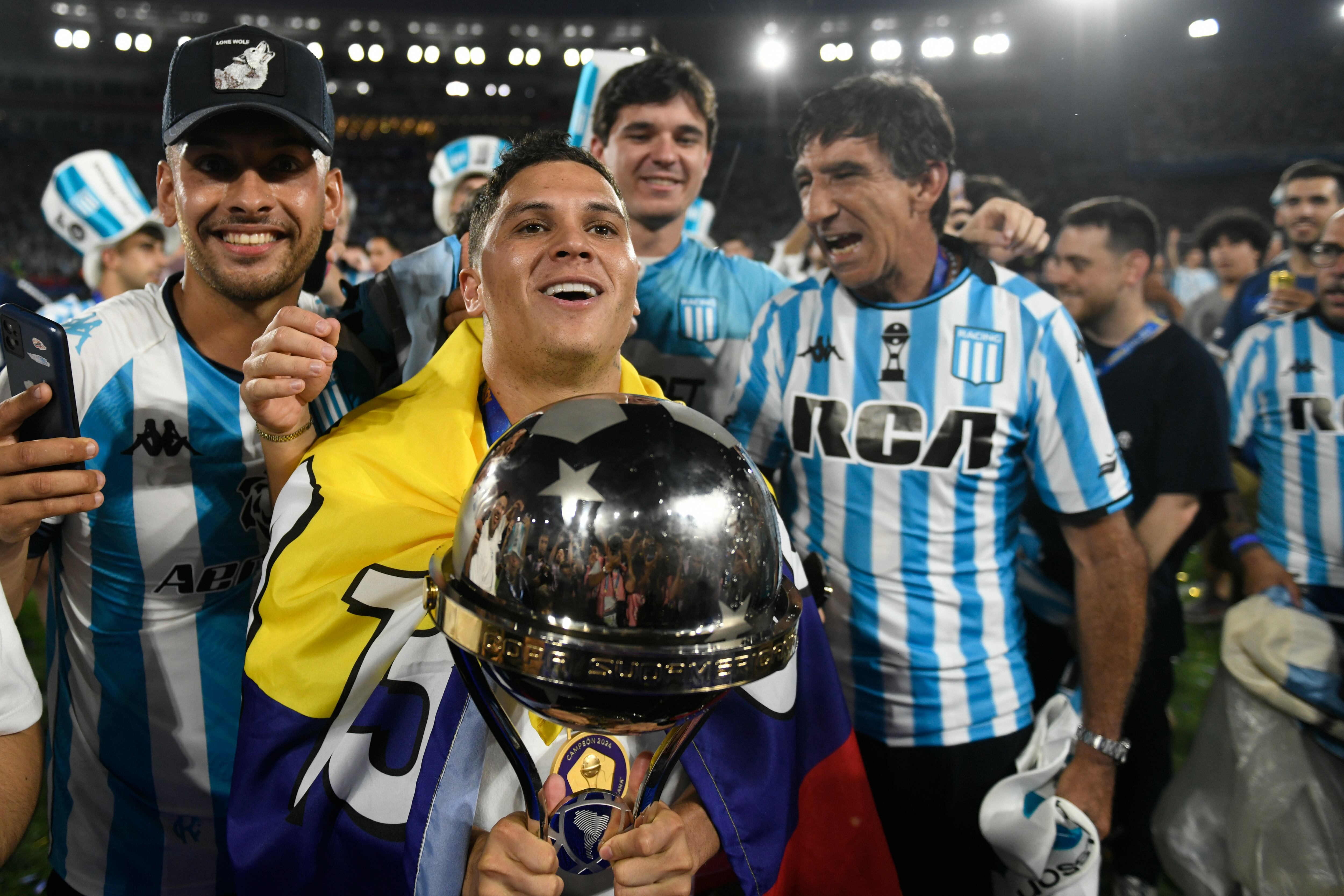 Juan Quintero, del Racing Club de Argentina, celebra con el trofeo tras ganar la final de la Copa Sudamericana contra el Cruzeiro de Brasil en Asunción, Paraguay, el sábado 23 de noviembre de 2024. (Foto AP/Gustavo Garello)