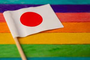 Japan flag on rainbow background symbol of LGBT gay pride month social movement rainbow flag is a symbol of lesbian, gay, bisexual, transgender, human rights, tolerance and peace.