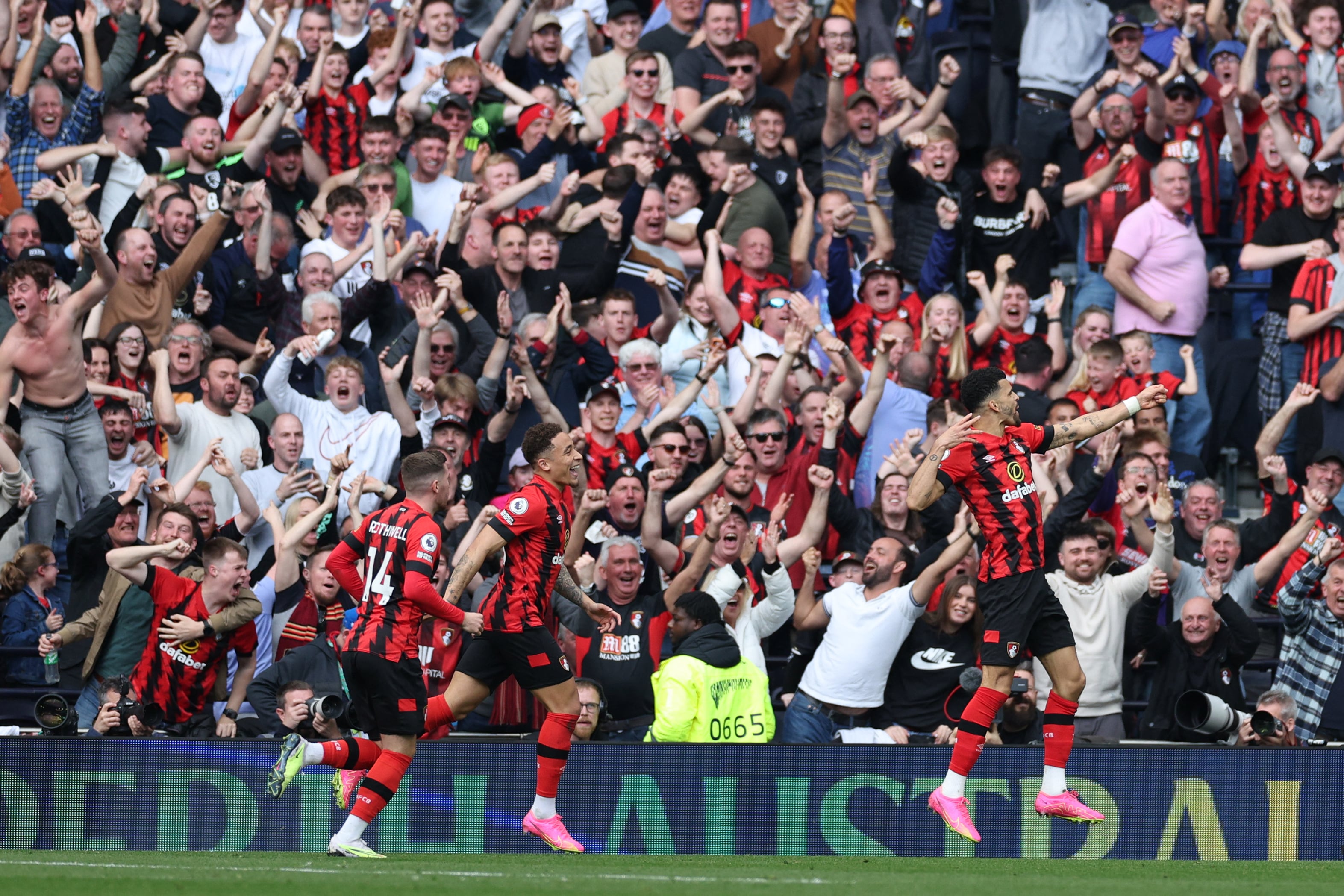 Bournemouth's English striker Dominic Solanke (R) celebrates with teammates after scoring his team second goal during the English Premier League football match between Tottenham Hotspur and Bournemouth at Tottenham Hotspur Stadium in London, on April 15, 2023. (Photo by Adrian DENNIS / AFP) / RESTRICTED TO EDITORIAL USE. No use with unauthorized audio, video, data, fixture lists, club/league logos or 'live' services. Online in-match use limited to 120 images. An additional 40 images may be used in extra time. No video emulation. Social media in-match use limited to 120 images. An additional 40 images may be used in extra time. No use in betting publications, games or single club/league/player publications. /