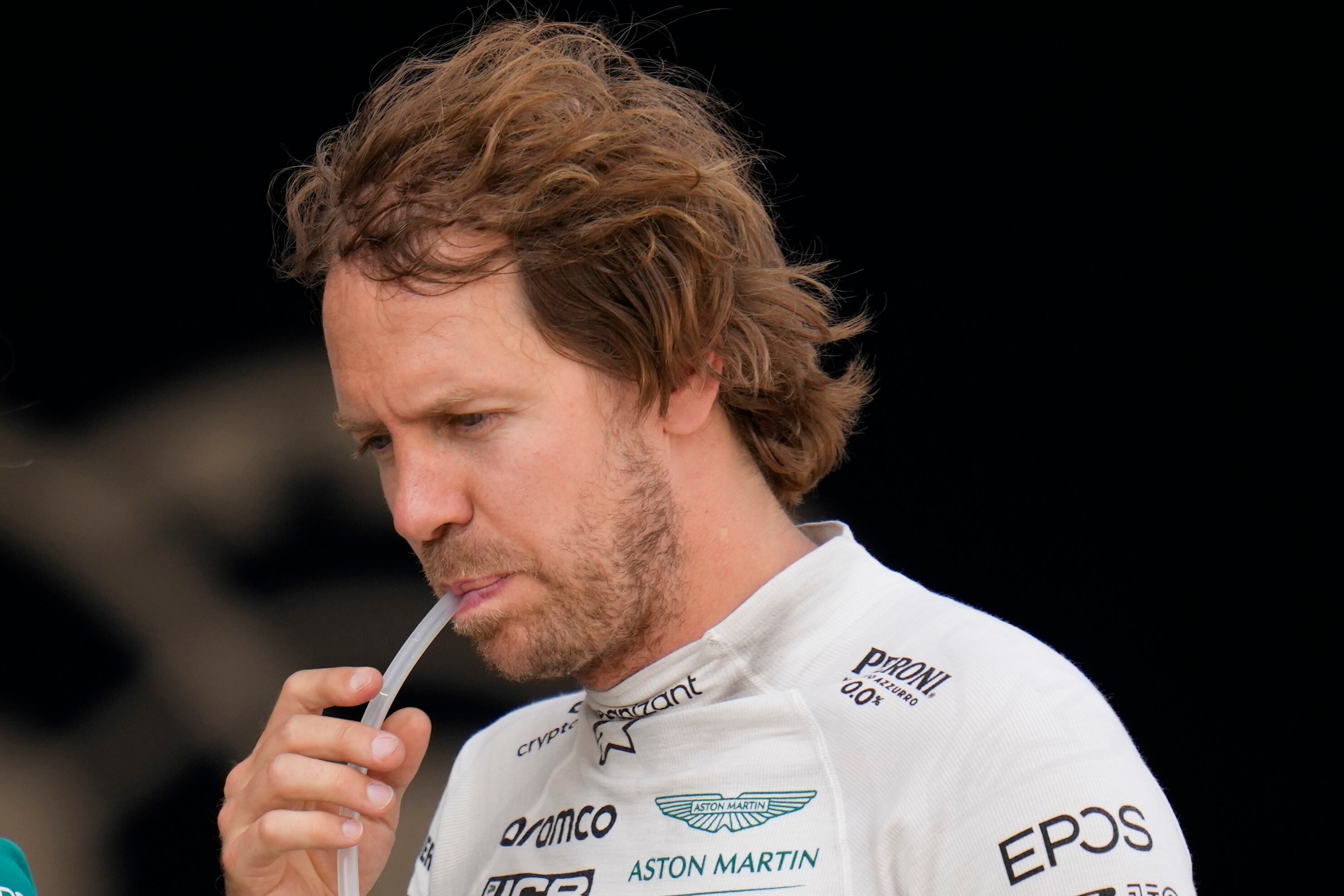 Aston Martin driver Sebastian Vettel of Germany walks at pits during the qualifying session at the Barcelona Catalunya racetrack in Montmelo, Spain, Saturday, May 21, 2022. The Formula One race will be held on Sunday. (AP Photo/Pool/Manu Fernandez)