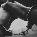 Praying for forgiveness in church. dark black and white, blurred cross of Jesus background