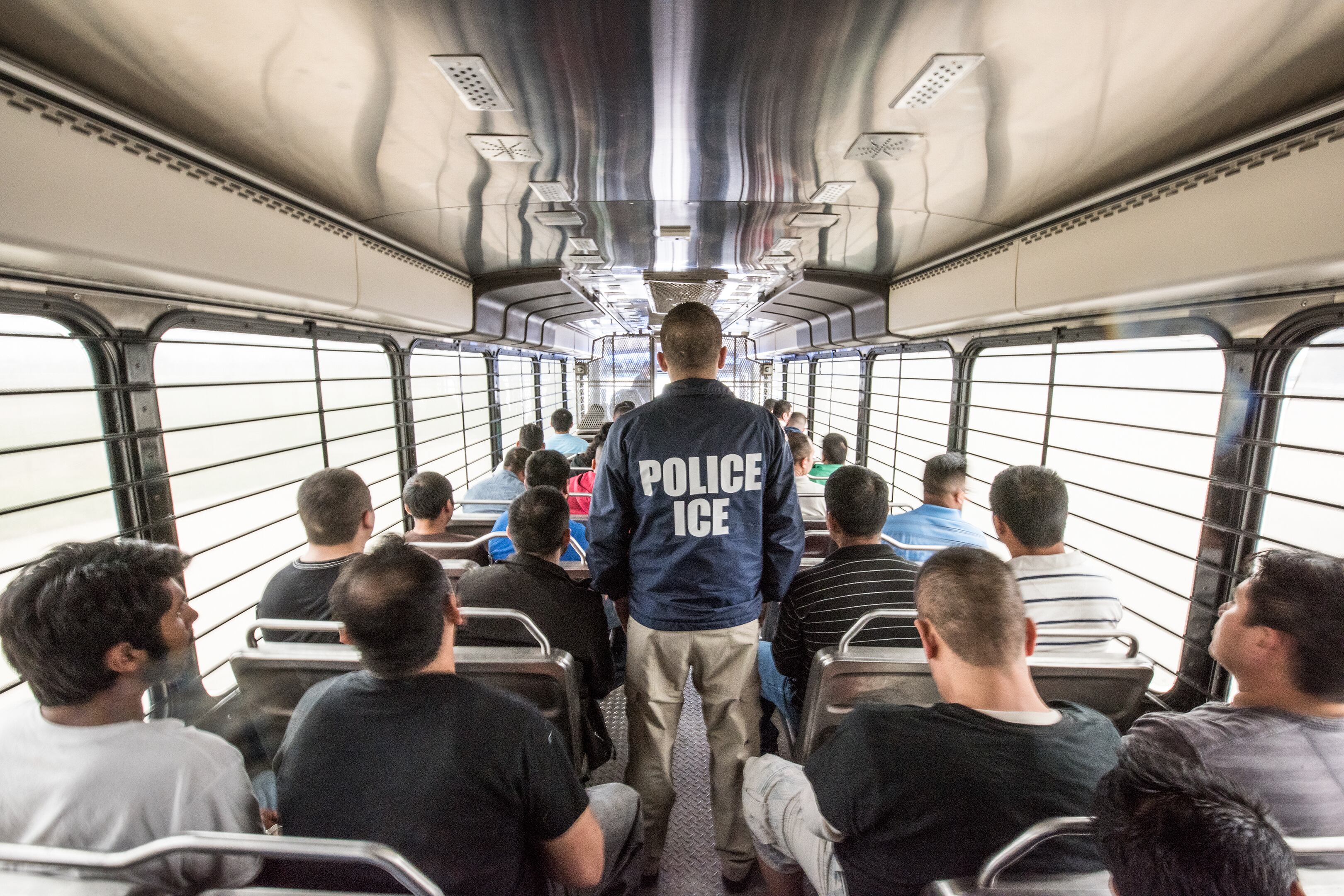 An ERO officer escorts aliens headed to an ICE detention facility in Chicago, Ill.