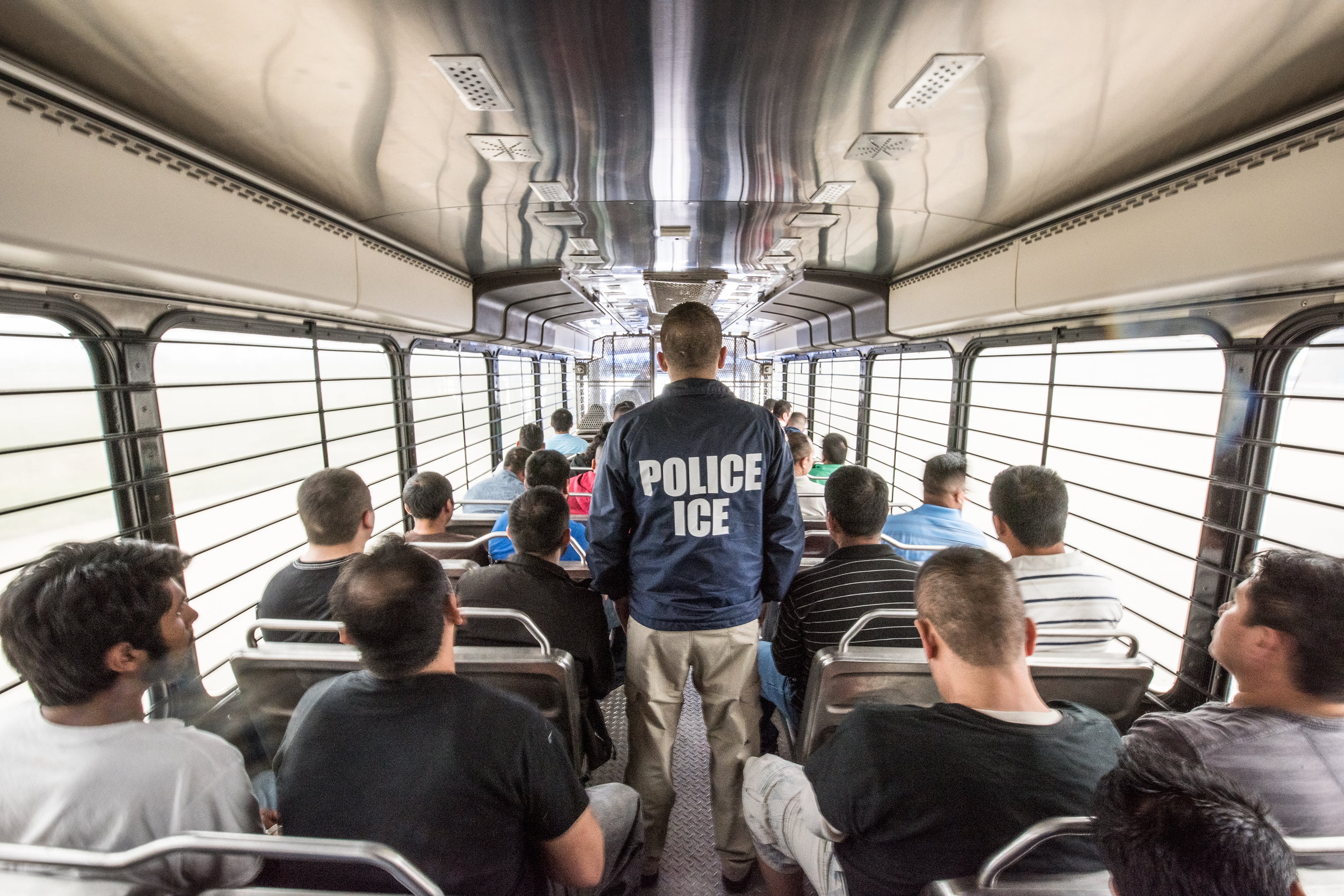 An ERO officer escorts aliens headed to an ICE detention facility in Chicago, Ill.