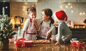 happy funny family mother and children bake christmas cookies