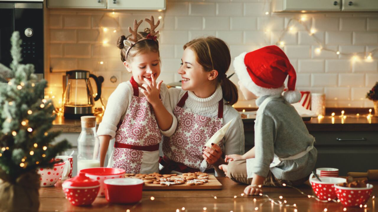 happy funny family mother and children bake christmas cookies