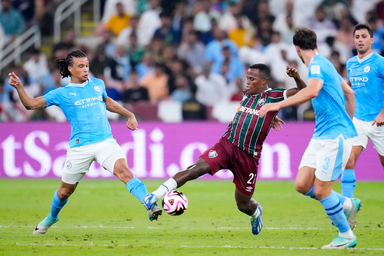 Manchester City's Nathan Ake, left, vies for the ball with Fluminense's Jhon Arias during the Soccer Club World Cup final match between Manchester City FC and Fluminense FC at King Abdullah Sports City Stadium in Jeddah, Saudi Arabia, Friday, Dec. 22, 2023. (AP Photo/Manu Fernandez)