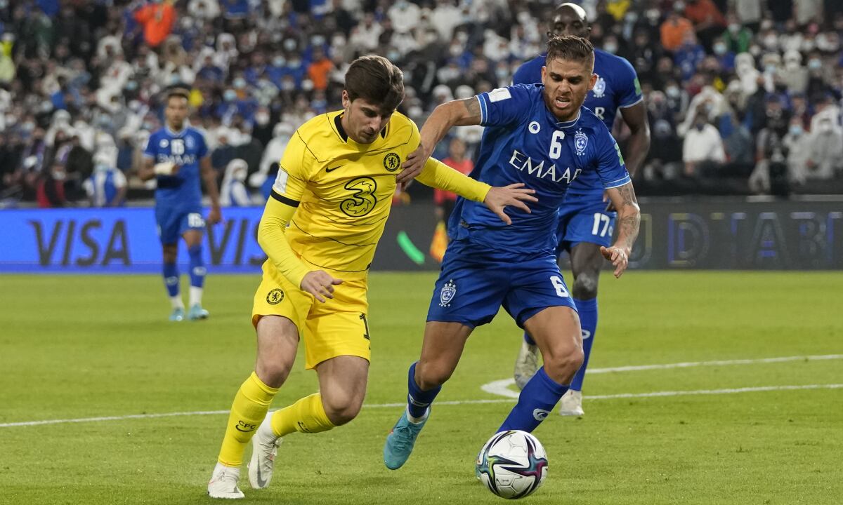 Chelsea's Mason Mount, left, and Al Hilal's Gustavo Cuellar fight for possession uring the Club World Cup semifinal soccer match between Al Hilal and Chelsea in Abu Dhabi, United Arab Emirates, Wednesday, Feb. 9, 2022. (AP/Hassan Ammar)
