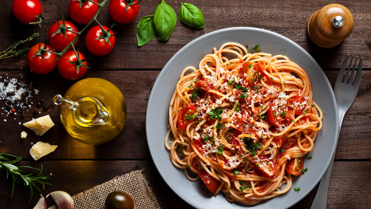 Pasta con Tomate. DSRL low key studio photo taken with Canon EOS 5D Mk II and Canon EF 100mm f/2.8L Macro IS USM