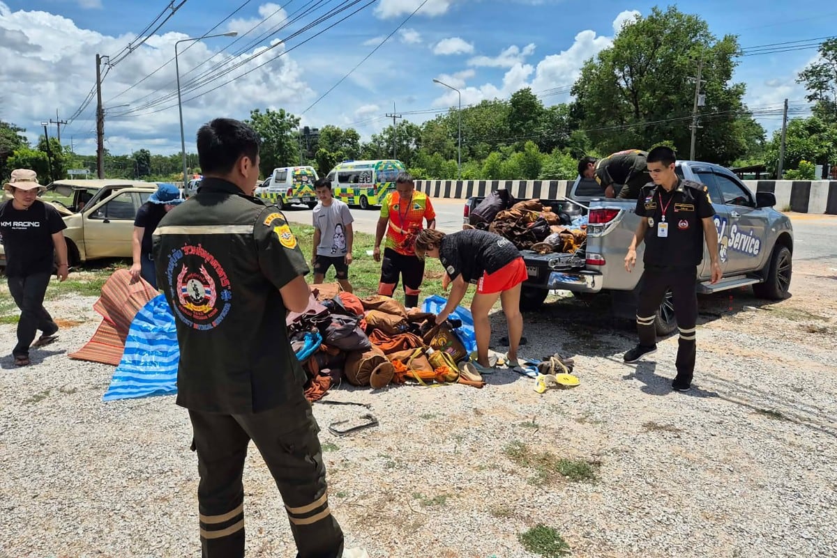 Esta imagen, difundida el 2 de julio de 2026 por la Fundación de Rescate Ruamjai Mukdahan, muestra a personas recogiendo las pertenencias de monjes budistas tras la colisión entre su procesión —que avanzaba por el arcén de la carretera— y una camioneta conducida por un menor de 11 años