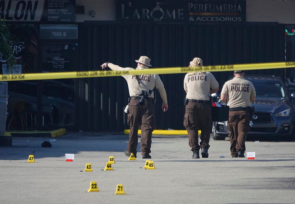Miami-Dade Police work the scene of a shooting outside a banquet hall near Hialeah, Fla., Sunday, May 30, 2021. Two people died and an estimated 20 to 25 people were injured in a shooting outside a banquet hall in South Florida, police said. The gunfire erupted early Sunday at the El Mula Banquet Hall in northwest Miami-Dade County, near Hialeah, police told news outlets. (Joe Cavaretta/South Florida Sun-Sentinel via AP)