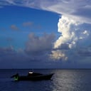 (FILES) This file photo taken on December 21, 2021 shows white gaseous clouds rising from the Hunga Ha'apai eruption seen from the Patangata coastline near Tongan capital Nuku'alofa. - Frightened Tongans fled to higher ground on January 15, 2022 after the latest eruption of the Hunga Tonga-Hunga Ha'apai volcano -- heard in neighbouring countries -- triggered tsunami warnings across the South Pacific. (Photo by Mary Lyn FONUA / AFP)