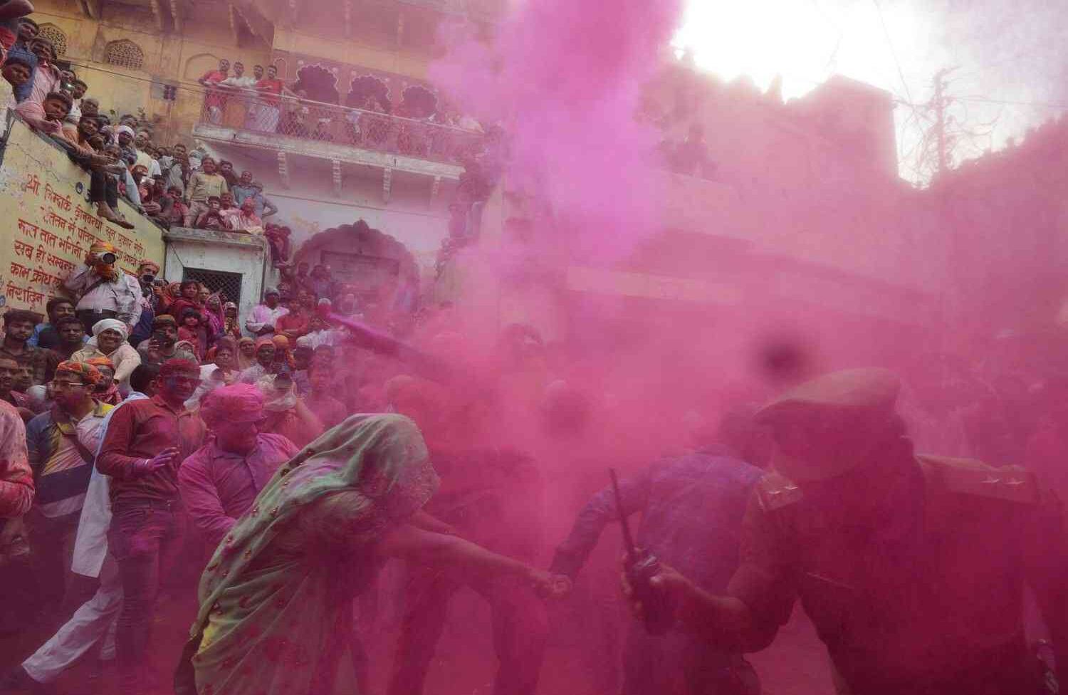 Polvo coloreado se arroja sobre aldeanos indios durante las celebraciones de Lathmar Holi en el pueblo de Barsana en las afueras de Mathura en el estado de Uttar Pradesh, al norte de la India, el 24 de febrero de 2018. Lathmar Holi es una celebración local del festival hindú de Holi, generalmente algunos días antes del festival de Holi. DOMINIQUE FAGET / AF 