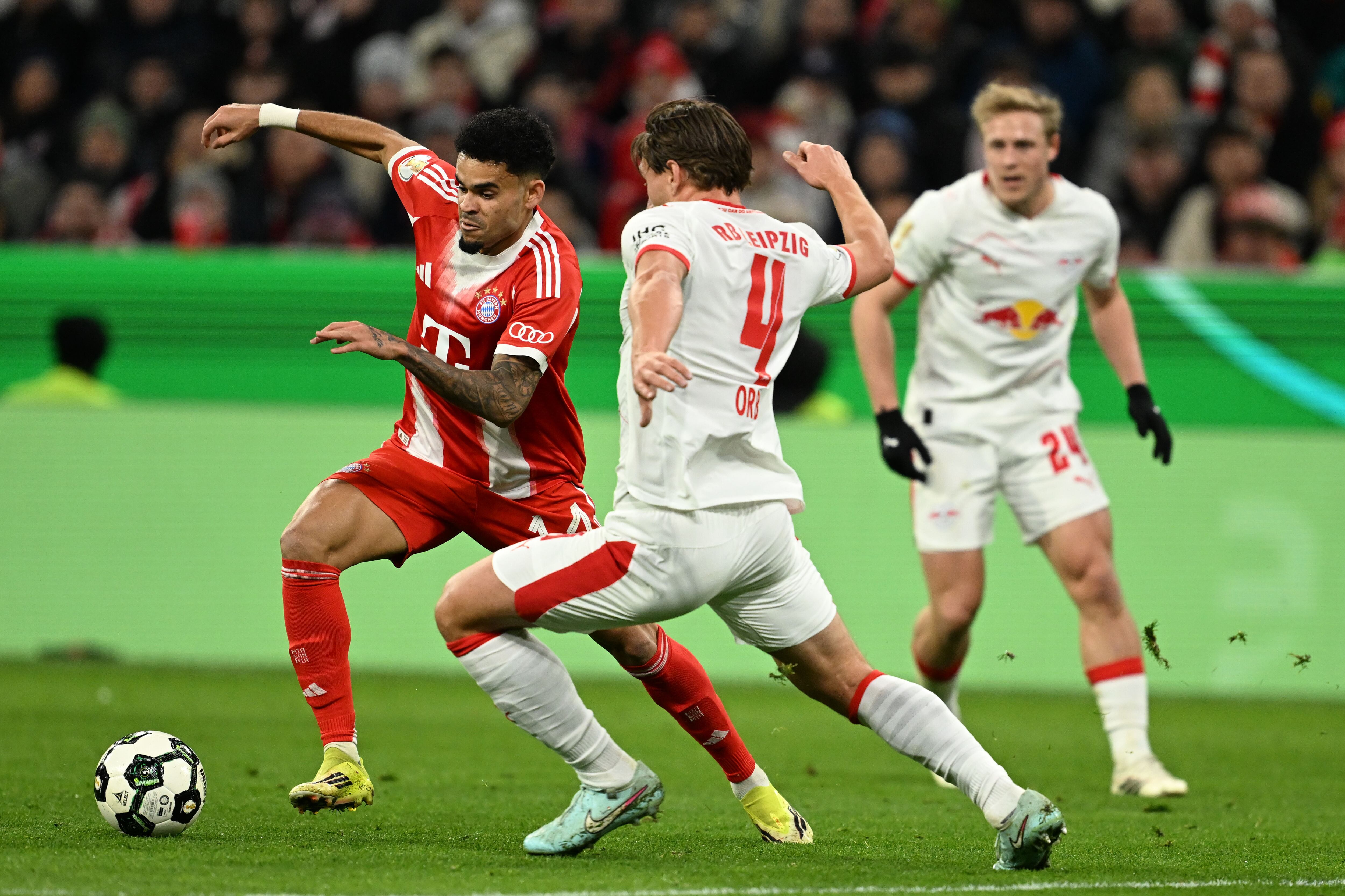 Bayern's Luis Diaz, left, and Leipzig's Willi Orban fight for the ball during the German Cup soccer match between Bayern Munich and RB Leipzig in Munich, Germany, Wednesday, Feb. 11, 2026. (Sven Hoppe/dpa via AP)