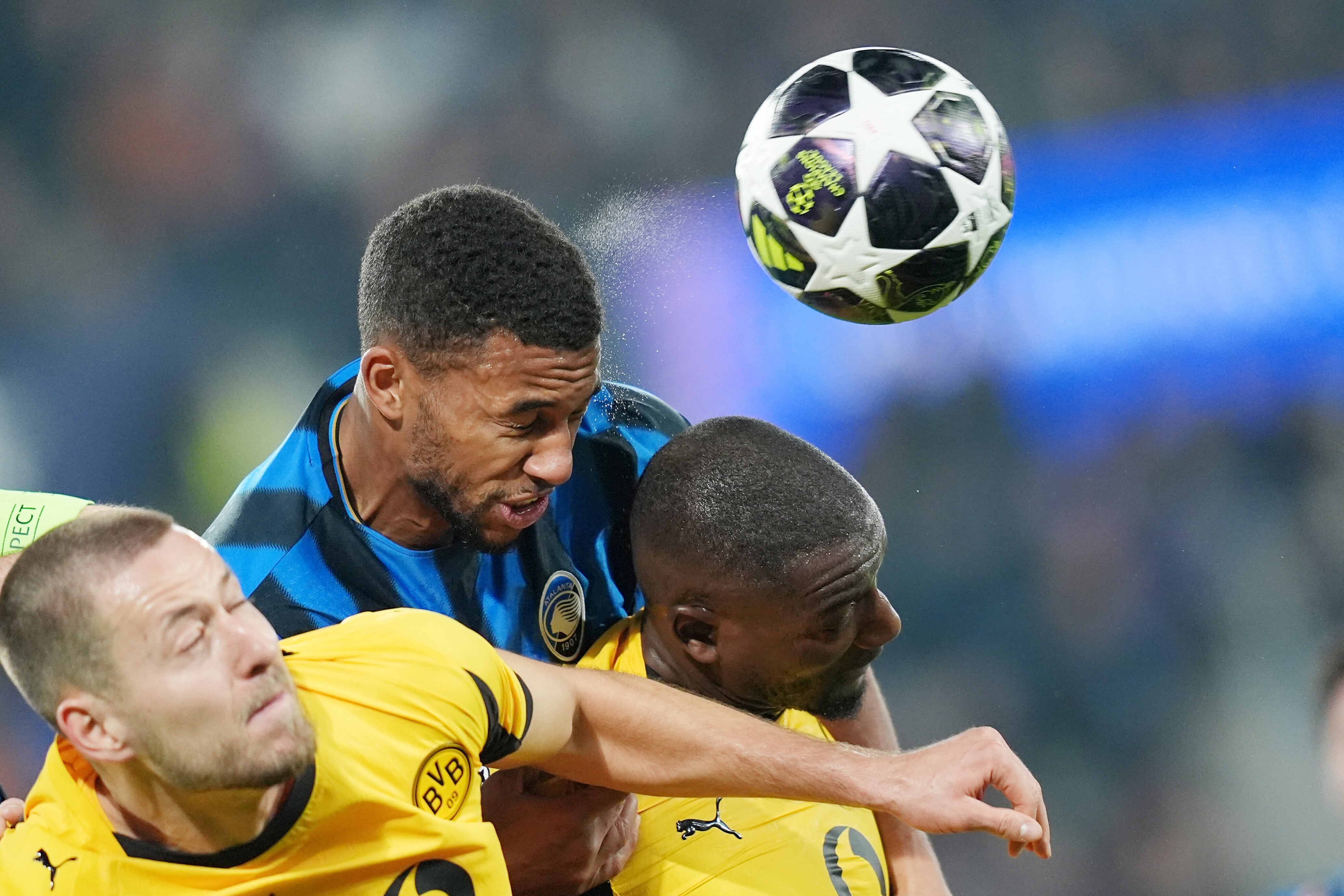 Atalanta's Isak Hien, top, fights for a head ball with Dortmund's Felix Nmecha, right, during the Champions League second leg playoff match between Atalanta and Borussia Dortmund in Bergamo, Italy, Wednesday, Feb. 25, 2026. (Spada/LaPresse via AP)