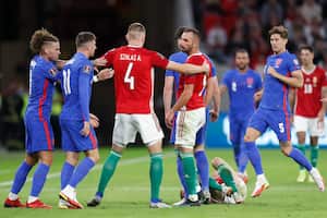 Hungary's Attila Szalai separates quarreling players during the World Cup 2022 group I qualifying soccer match between Hungary and England at the Ferenc Puskas stadium in Budapest, Hungary, Thursday, Sept. 2, 2021. (AP Photo/Laszlo Balogh)