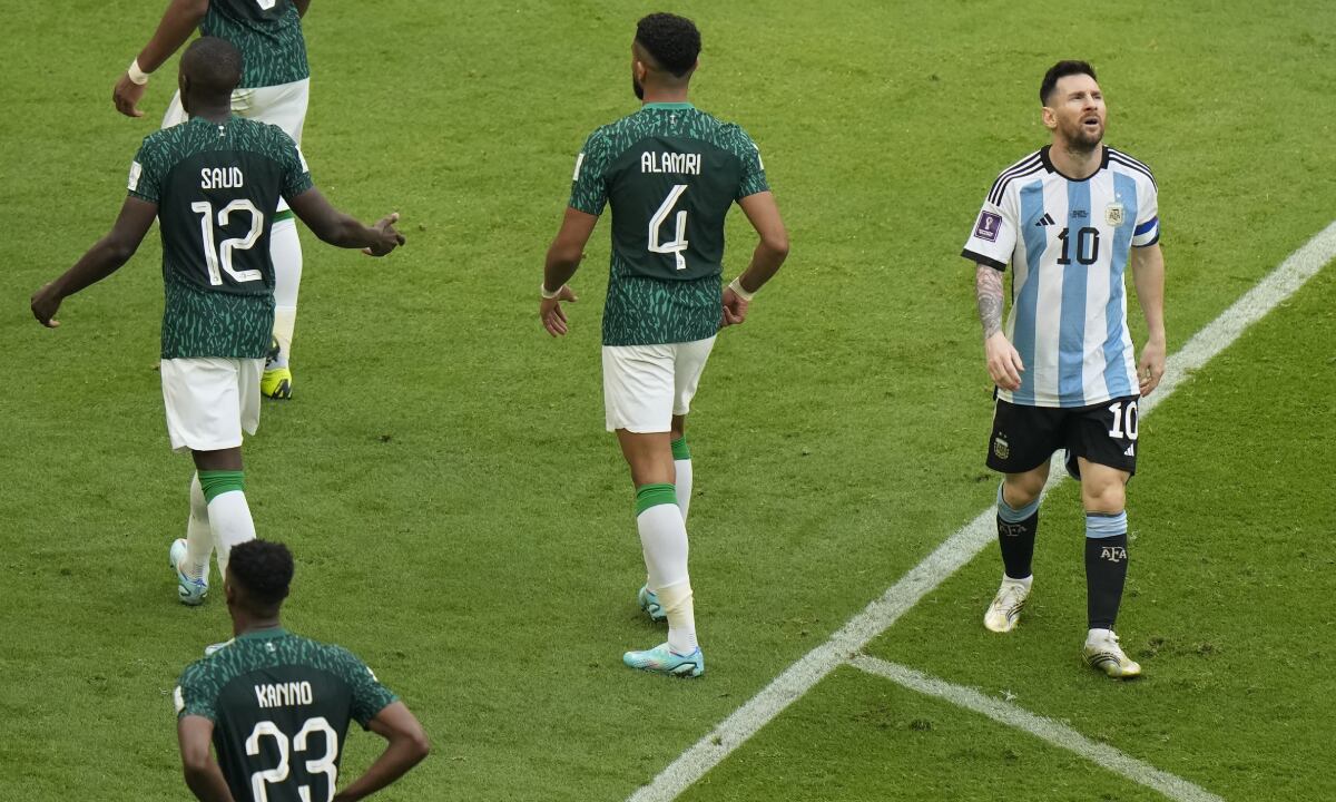 Argentina's Lionel Messi, right, reacts during the World Cup group C soccer match between Argentina and Saudi Arabia at the Lusail Stadium in Lusail, Qatar, Tuesday, Nov. 22, 2022. (AP/Luca Bruno)