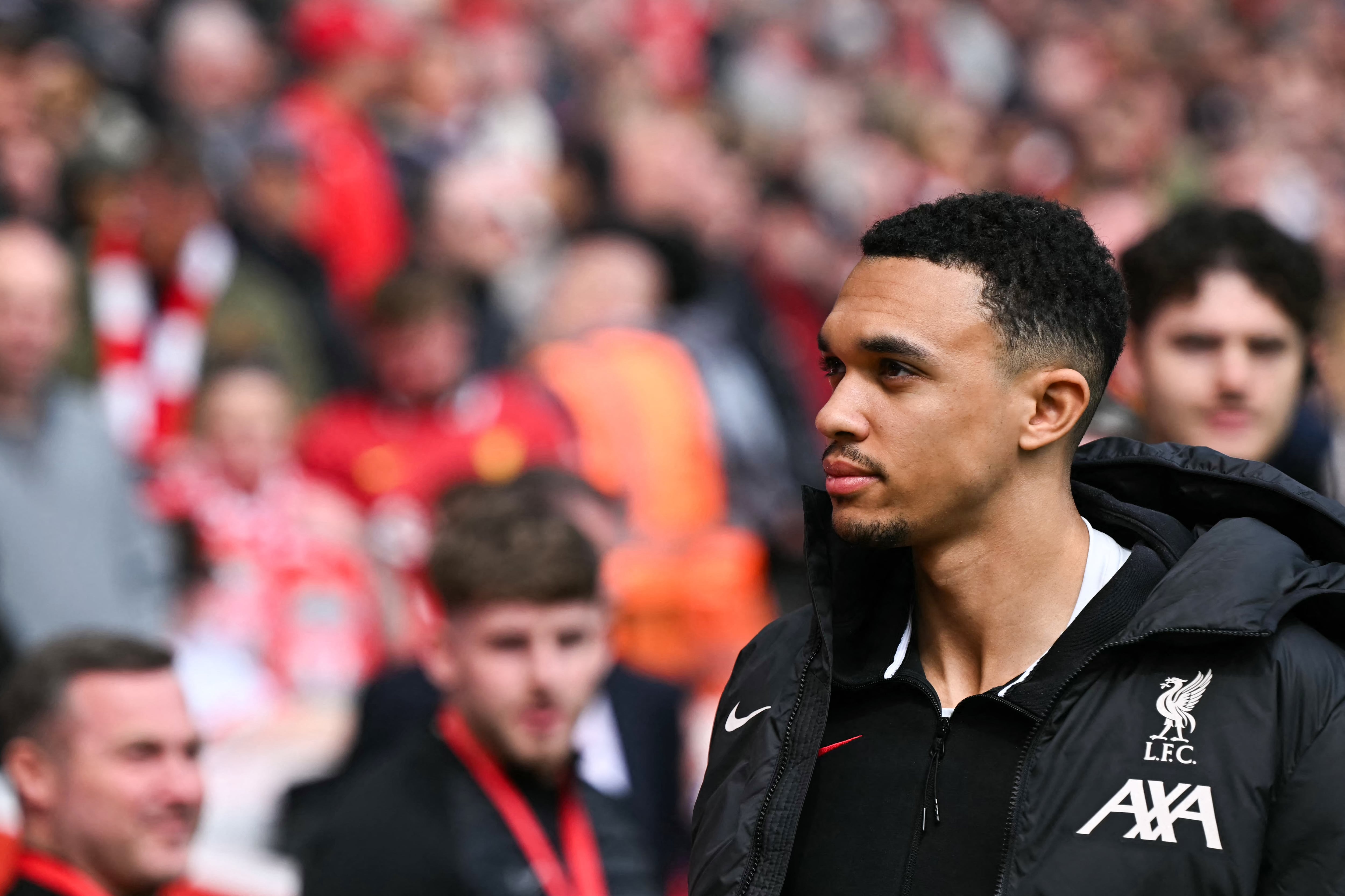 Liverpool's English defender #66 Trent Alexander-Arnold reacts as he arrives prior to the English Premier League football match between Liverpool and West Ham United at Anfield in Liverpool, north west England on April 13, 2025. (Photo by Paul ELLIS / AFP) / RESTRICTED TO EDITORIAL USE. NO USE WITH UNAUTHORIZED AUDIO, VIDEO, DATA, FIXTURE LISTS, CLUB/LEAGUE LOGOS OR 'LIVE' SERVICES. ONLINE IN-MATCH USE LIMITED TO 120 IMAGES. AN ADDITIONAL 40 IMAGES MAY BE USED IN EXTRA TIME. NO VIDEO EMULATION. SOCIAL MEDIA IN-MATCH USE LIMITED TO 120 IMAGES. AN ADDITIONAL 40 IMAGES MAY BE USED IN EXTRA TIME. NO USE IN BETTING PUBLICATIONS, GAMES OR SINGLE CLUB/LEAGUE/PLAYER PUBLICATIONS. /
