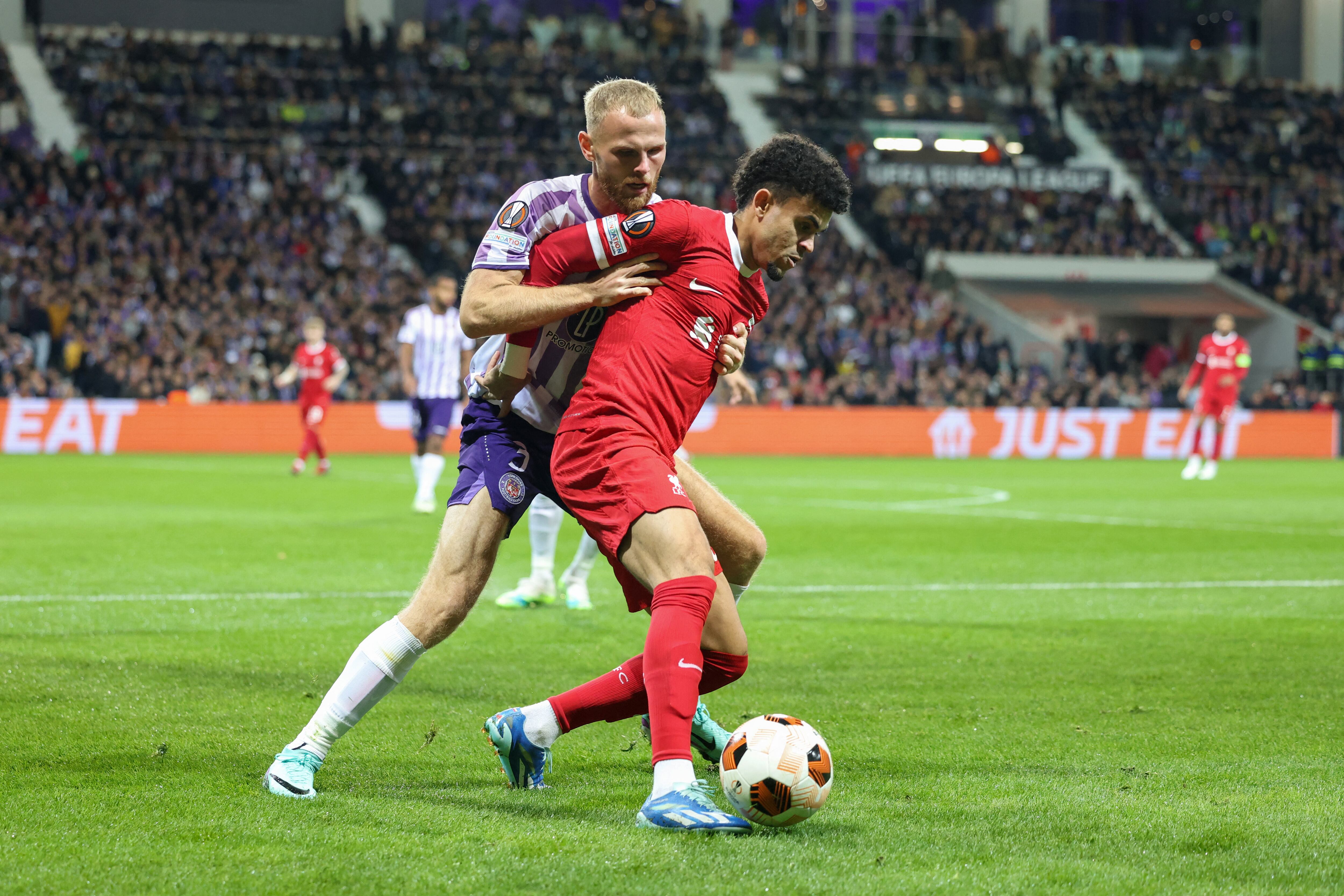 Liverpool's Colombian midfielder #07 Luis Diaz (R) and Toulouse's Danish defender #03 Mikkel Desler Puggaard (L) fight for the ball during the UEFA Europa League Group E football match between Toulouse FC (TFC) and Liverpool at the Stadium de Toulouse, in Toulouse, southwestern France on November 9, 2023. (Photo by Charly TRIBALLEAU / AFP)