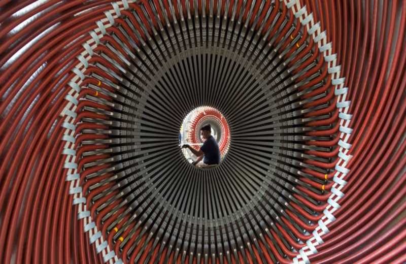 Un trabajador se ve entre el gigantesco generador de la planta Siemens, en Erfurt, , Alemania.