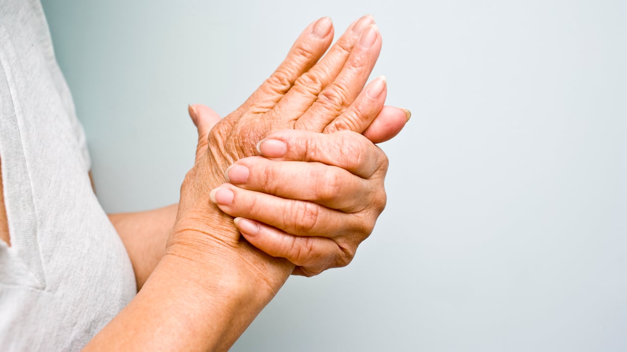 Senior woman holding her arthritic hands