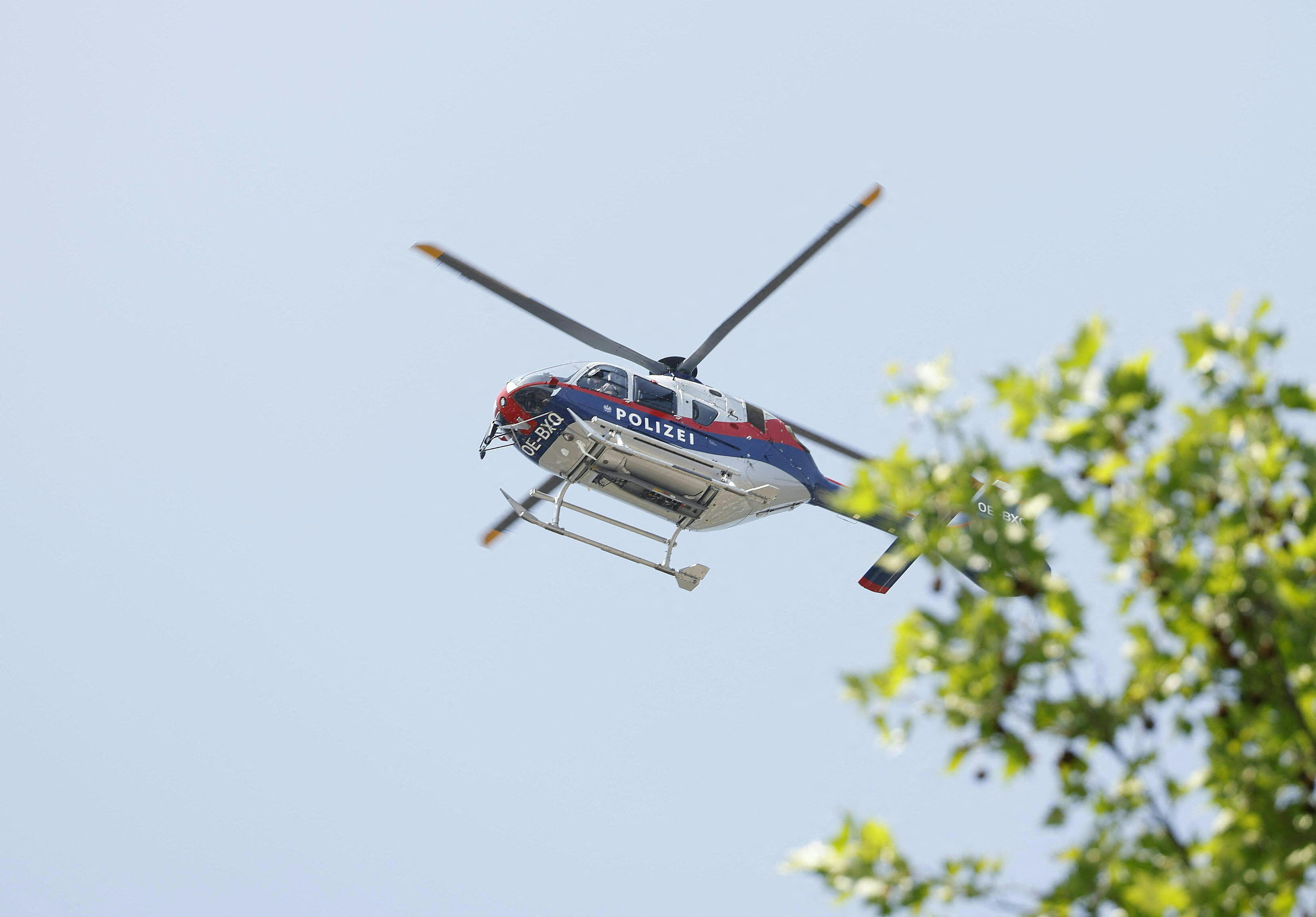 A police helicopter is seen in the air close to a school where, according to reports, several people died in a shooting, on June 10, 2025 in Graz, southeastern Austria. Several people died in a school shooting, including the attacker, Austrian broadcaster ORF quoted the interior ministry as saying. (Photo by ERWIN SCHERIAU / APA / AFP) / Austria OUT / AUSTRIA OUT / AUSTRIA OUT