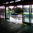 Speeding cars over a wet street from a bus station in a rainy day