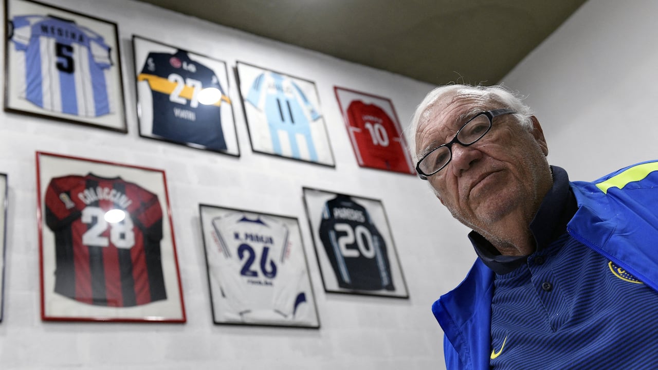 Argentinian football talent scout Ramon Maddoni poses next to jerseys given to him by football stars he scouted at Club Parque in Buenos Aires on March 22, 2018. Maddoni is a legend among football talent scouts. Over 100 players were scouted by him, including Carlos Tevez -who played in Argentinian Boca Juniors, Manchester United, Manchester City and Italian Juventus-, Fernando Redondo -who played in Spanish Real Madrid and Italian Milan- and Esteban Cambiasso -who played in Spanish Real Madrid and Italian Inter. (Photo by JUAN MABROMATA / AFP) / TO GO WITH AFP STORY BY DANIEL MEROLLA