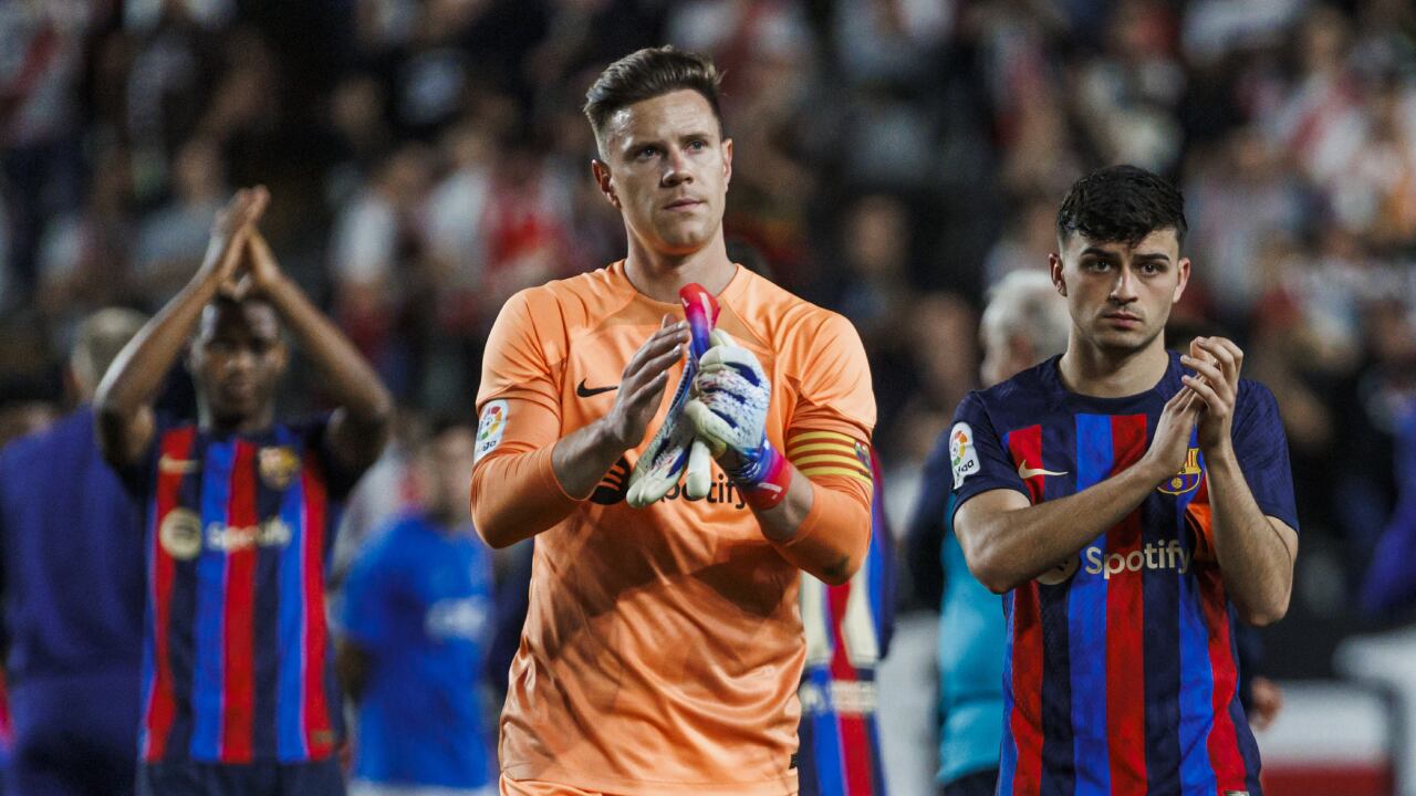 Barcelona's goalkeeper Marc-Andre ter Stegen, centre, Ansu Fati, left and Pedri applaud the fans at the end of a Spanish La Liga soccer match between Rayo Vallecano and Barcelona at the Vallecas stadium in Madrid, Spain, Wednesday, April 26, 2023. (AP/Pablo Garcia)