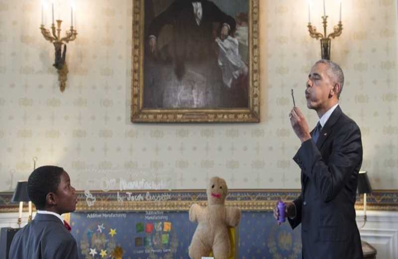 El presidente de Estados Unidos, Barack Obama, sopla unas burbujas de jabón con un artefacto creado con una impresora 3D, durante la feria de ciencias de la Casa Blanca. 