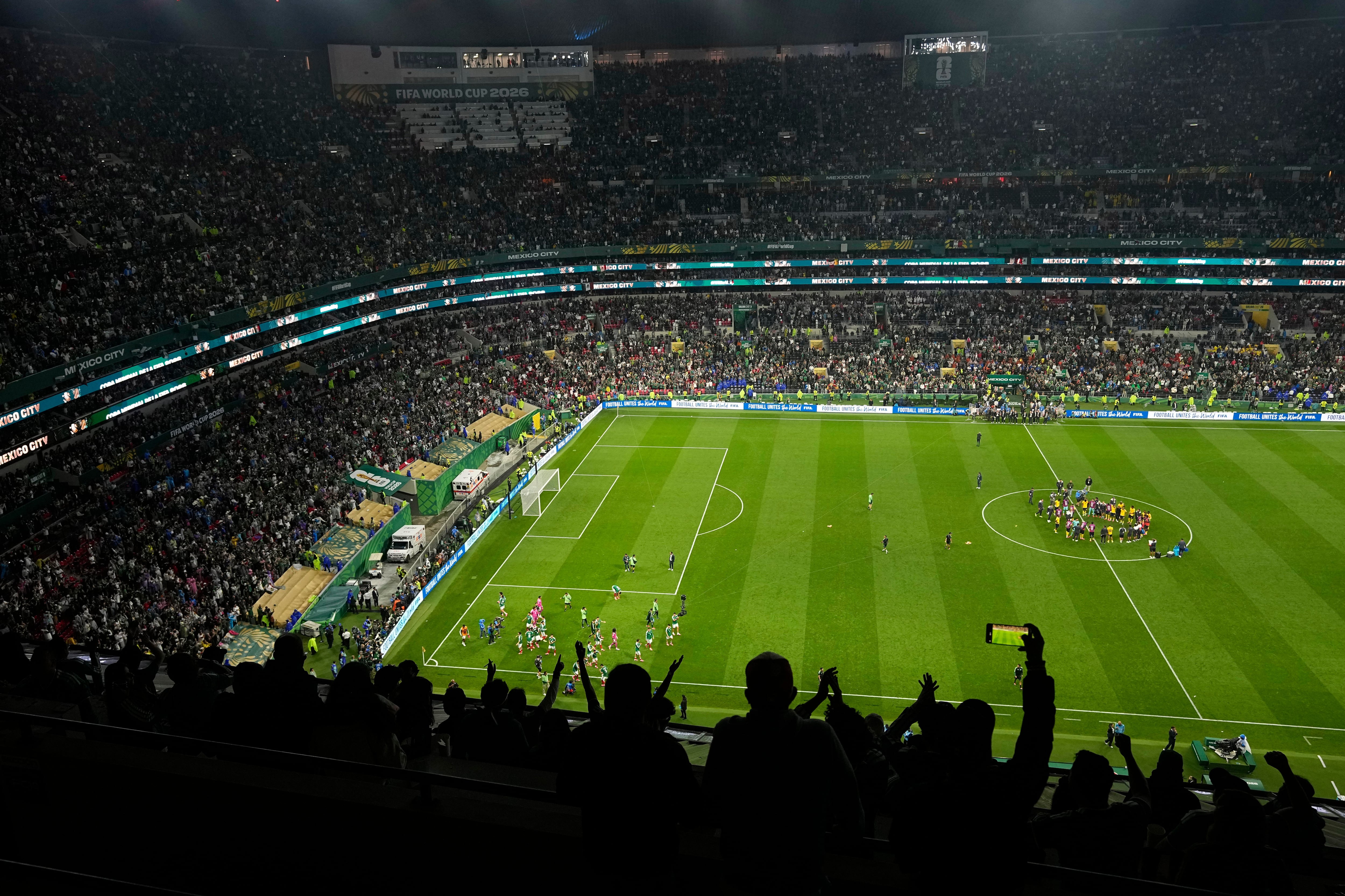 Fans cheer after the World Cup round of 32 soccer match between Mexico and Ecuador in Mexico City, Tuesday, June 30, 2026. (AP Photo/Silvia Izquierdo)
