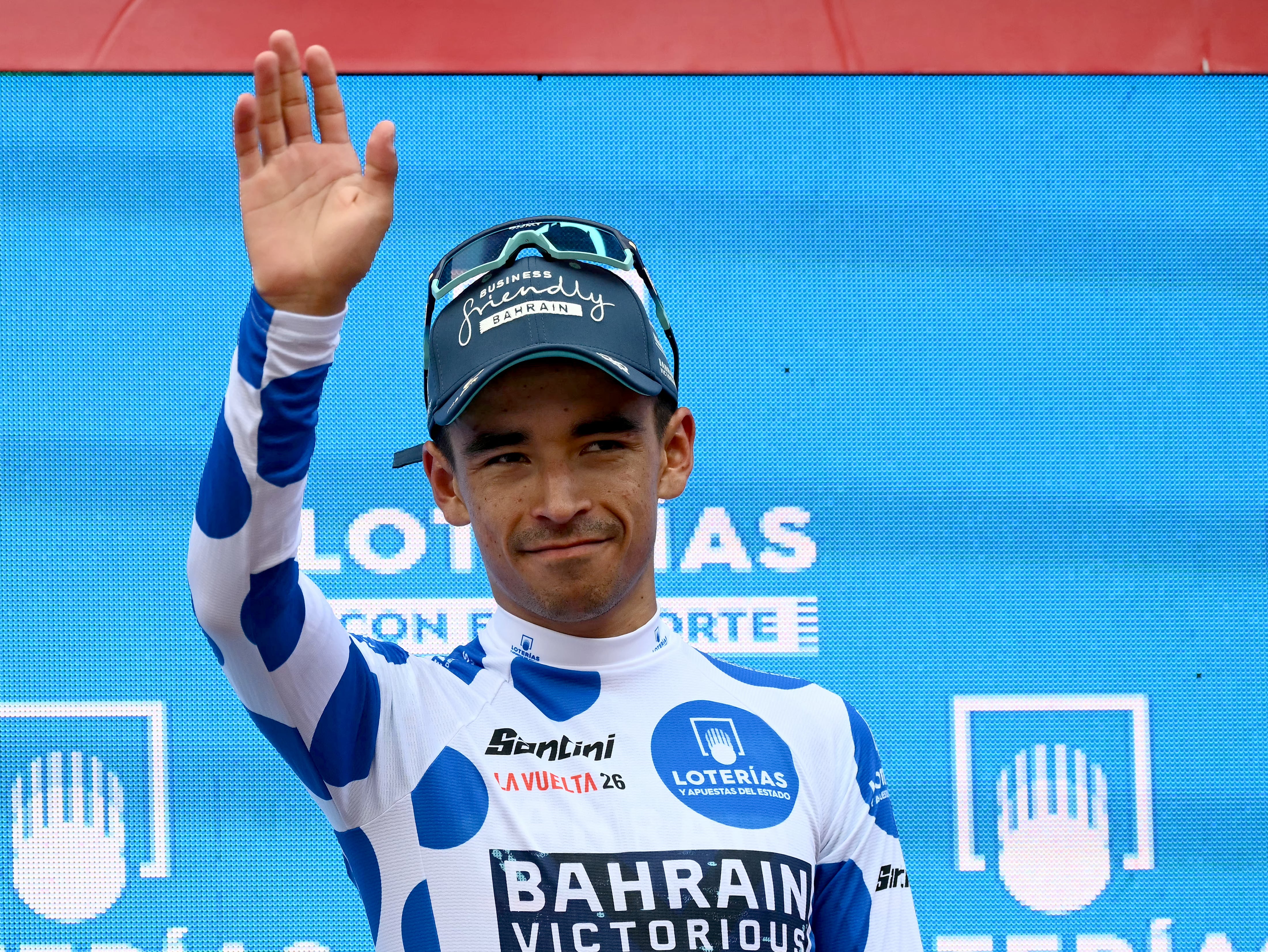Team Bahrain's Colombian rider Santiago Buitrago celebrates on the podium wearing the best climber's dotted jersey after the 11th stage of the Vuelta a Espana 2026 cycling tour, a 151,3 km race between Carthagena and Lorca, on September 2, 2026. (Photo by JOSE JORDAN / AFP)