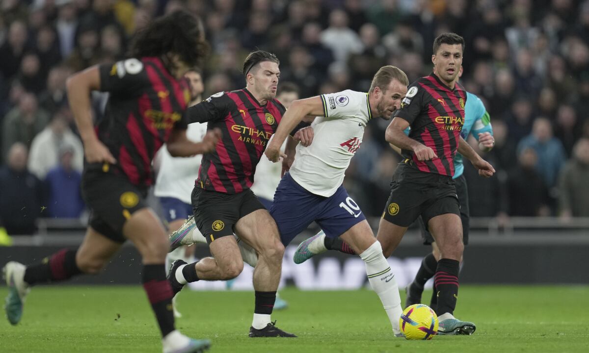 Tottenham's Harry Kane, 3rd left, is challenged by Manchester City's Jack Grealish, 2nd left, during an English Premier League soccer match between Tottenham Hotspur v Manchester City at the Tottenham Hotspur Stadium in London, Sunday, Feb. 5, 2023. (AP/Kin Cheung)