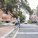 blonde girl taking with film camera in a city, exploring a city with a vintage camera