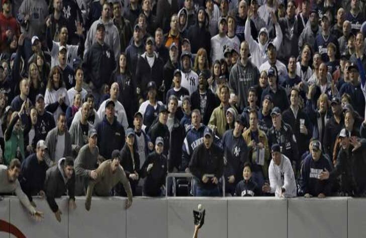 Fans de los Yankees tratan de distraer al jardinero izquierdo de Los Angeles, Juan Rivera, en el Yankee Stadium, el 25 de octubre.
