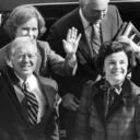 FILE - Former President Jimmy Carter and his wife, Rosalynn, back left, wave to photographers on the City Hall balcony as they arrived with San Francisco Mayor Dianne Feinstein, right, in San Francisco, Tuesday, Feb. 1, 1983. Carter's meeting with the mayor was canceled when a caller phoned in a routine bomb threat, the Secret Service said. (AP Photo/Eric Risberg, File)
