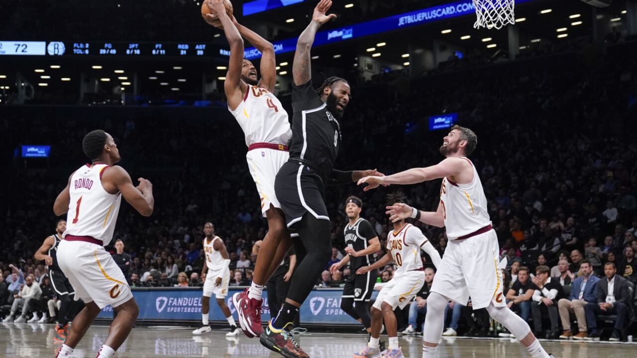 Cleveland Cavaliers' Evan Mobley, center left, and Brooklyn Nets' Andre Drummond, center right, vie for a rebound during the second half of the opening basketball game of the NBA play-in tournament, Tuesday, April 12, 2022, in New York. The Nets won 115-108. (AP/Seth Wenig)