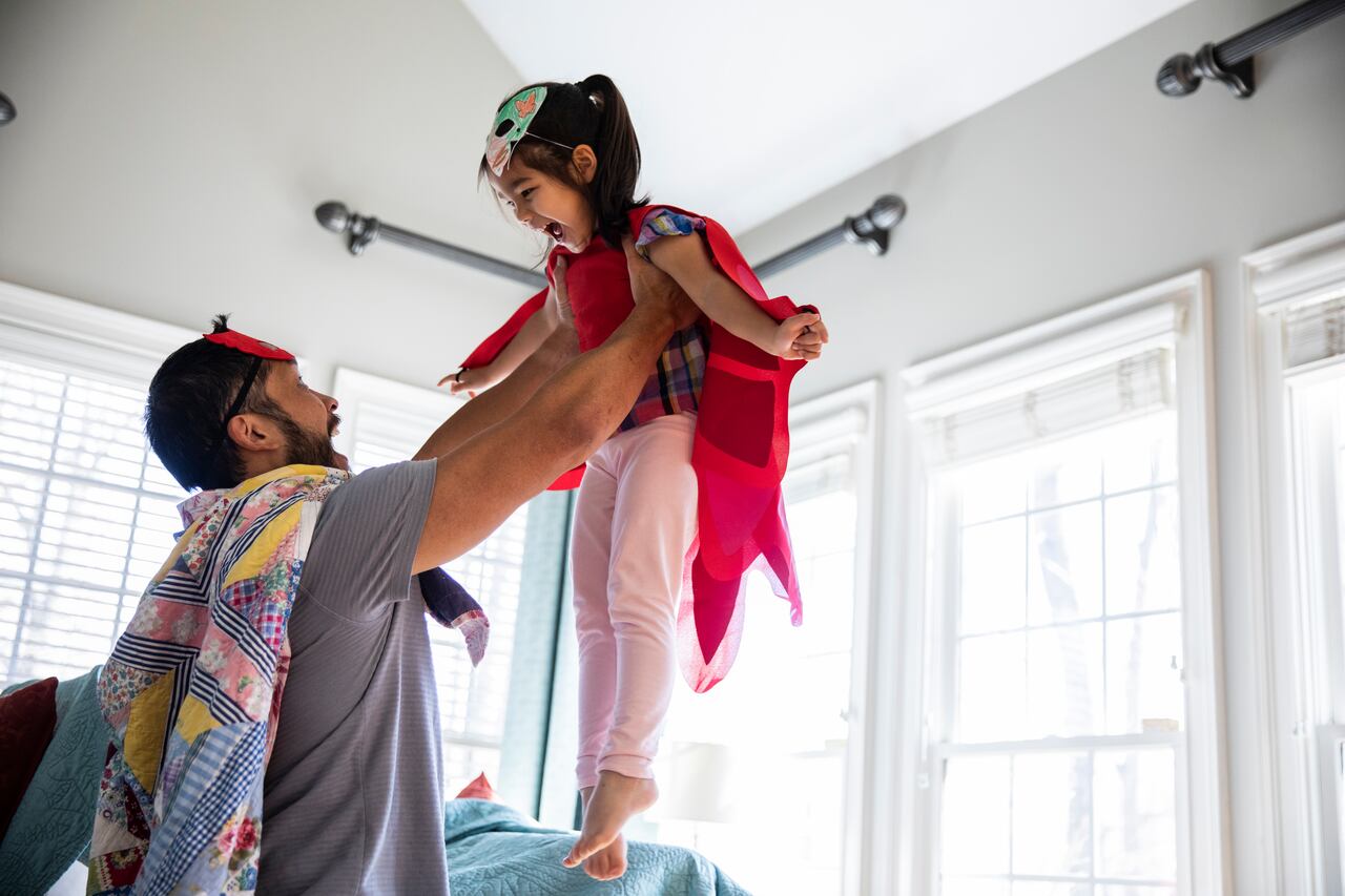 Father and daughter playing in homemade costumes