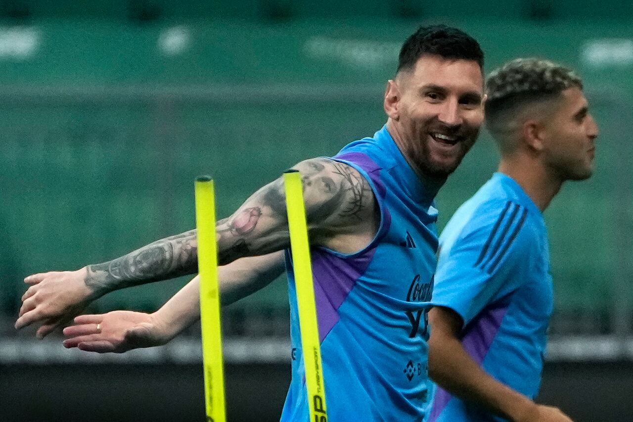 Lionel Messi reacts as he jogs with his teammates of Argentina's national soccer team as they practice one day ahead of their friendly soccer match against Australia in Beijing, Wednesday, June 14, 2023. (AP Photo/Andy Wong)