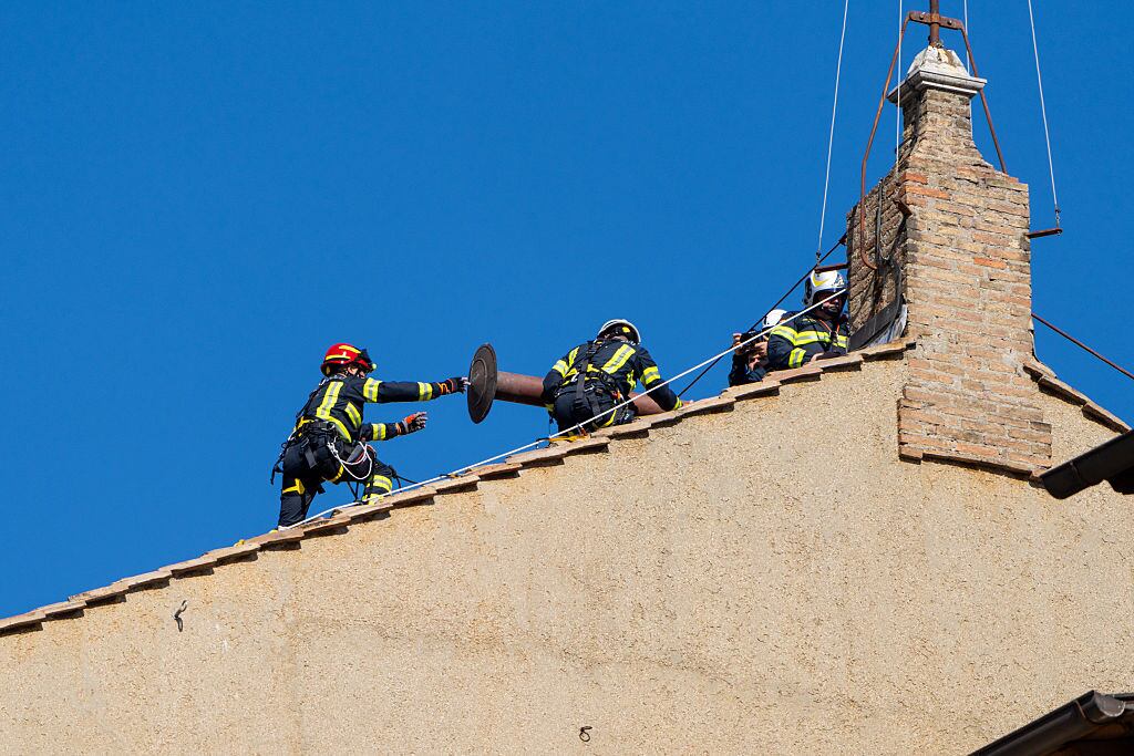 Vatican firefighters set up the chimney atop the Sistine Chapel for the upcoming Conclave. (Photo by Massimo Valicchia/NurPhoto via Getty Images)