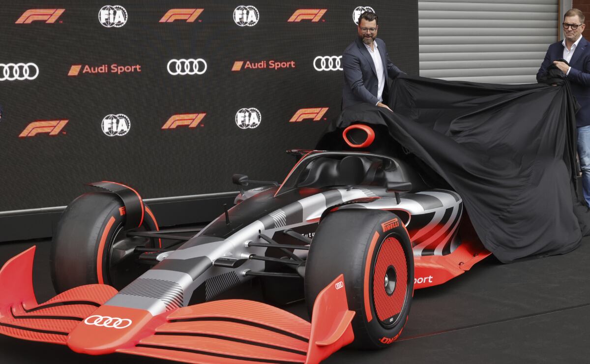 Audi CEO Markus Duesmann, right, and Audi's Chief Development Officer Oliver Hoffman unveil the new Audi F1 car during a media conference ahead of the Formula One Grand Prix at the Spa-Francorchamps racetrack in Spa, Belgium, Friday, Aug. 26, 2022. German manufacturer Audi will enter Formula One in 2026 in line with new engine regulations, chairman Markus Duesmann said on Friday. (AP/Olivier Matthys)