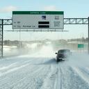A single driver navigates MoPac Boulevard on the bridge over Lady Bird Lake after a heavy snow on Monday, Feb. 15, 2021, in Austin, Texas. (Jay Janner/Austin American-Statesman via AP)